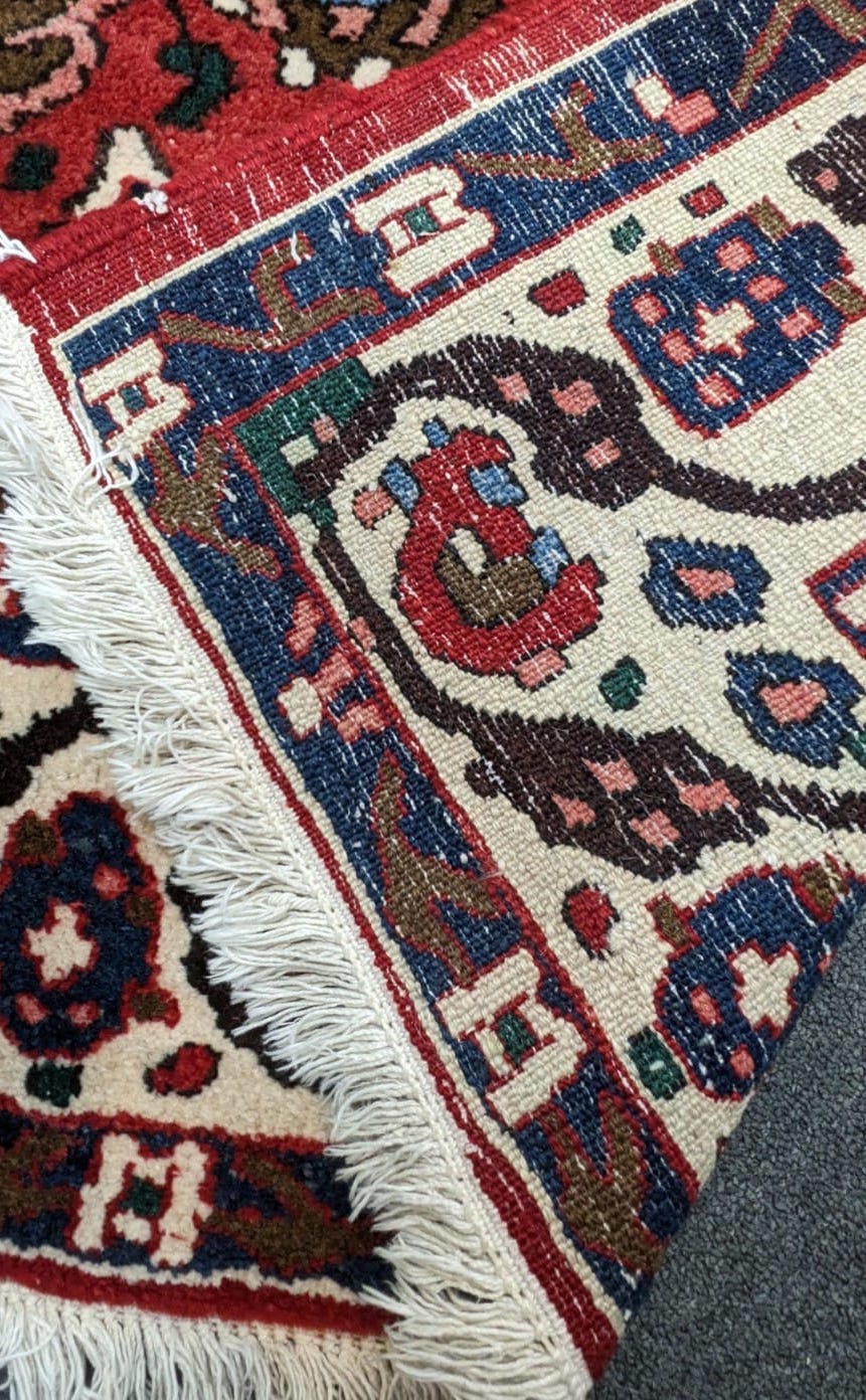 A Persian red ground rug, 204 x 151cm